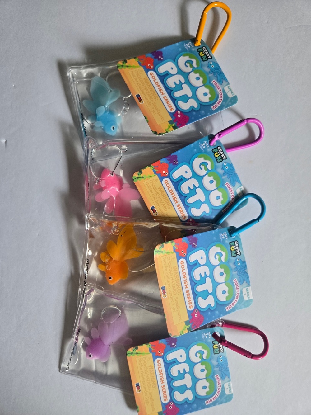 Goo Pets Squishy Goldfish Keychain Pack — Blue, Pink, Orange, Purple